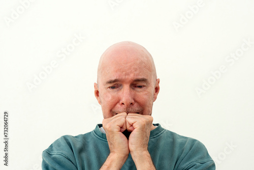 Man biting his knucles, emotional expressions. photo