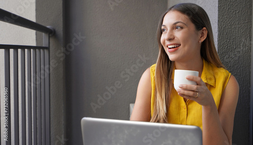 Creative young woman working from home on the balcony. Smart work. Home office.