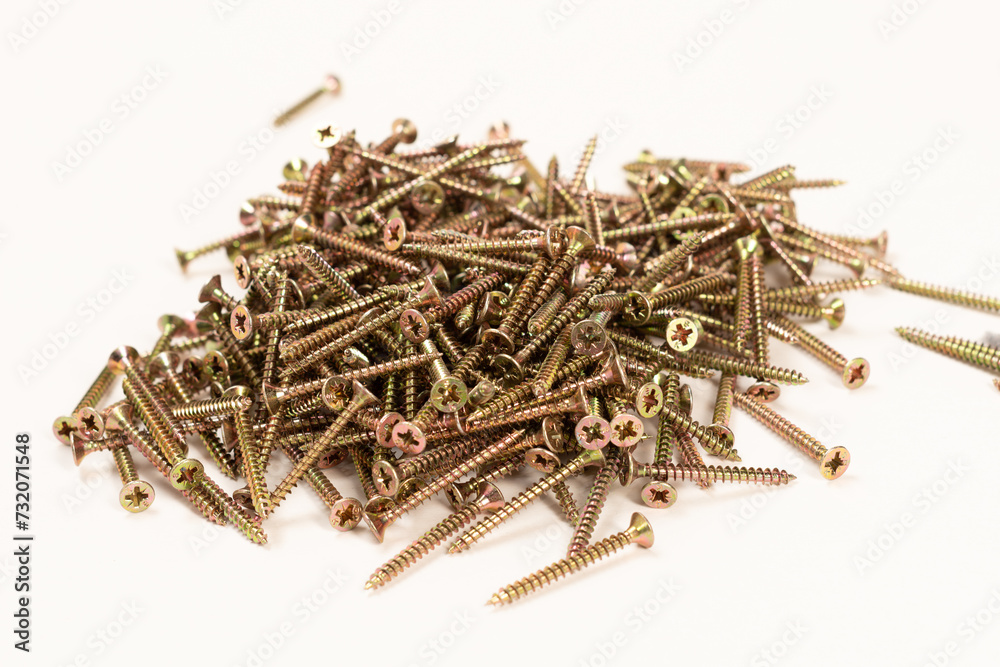  Scattered screws on a white background, bolts , screws for mounting in wooden walls isolated on a white background 