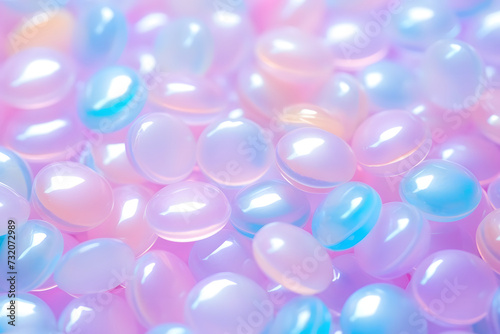 Close-up of a pile of smooth, round, pastel-colored pebbles. Isolated on a pastel pink background.