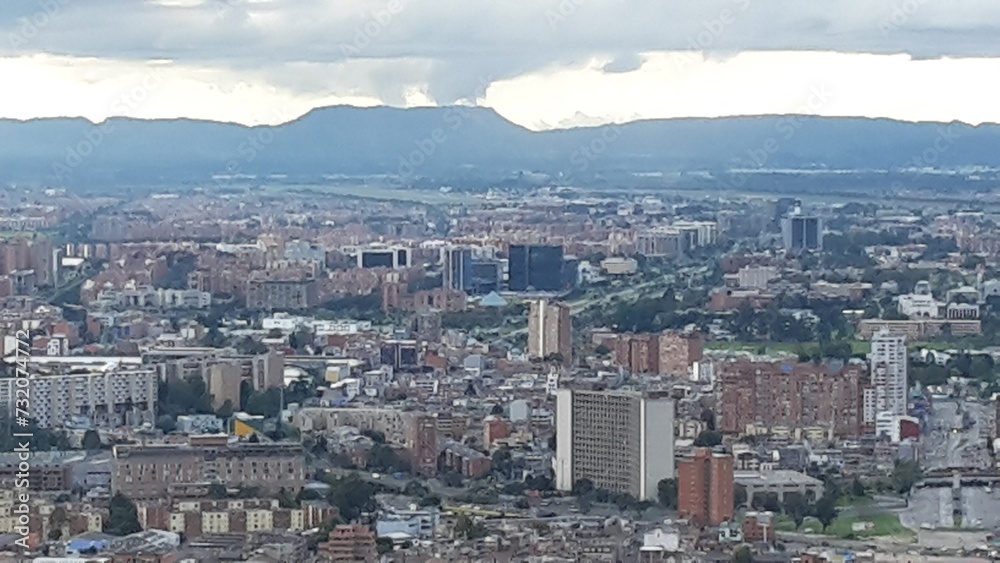 Aerial view to the north, urban landscape full of tall buildings surrounded by mountains in Bogotá, Colombia.