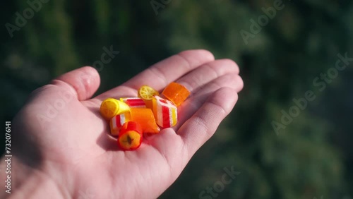 Cinematic 4K shot of a man holding homemade candies in a sunny forest setting