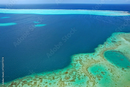 Aerial view of turquoise water and the coral reef in the South Pacific Ocean near the island of Raiatea on the south eastern coast of Raiatea