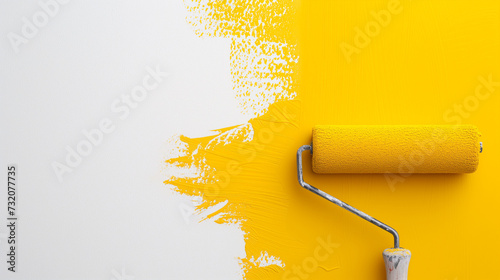 Image of a paint roller painting a white wall with yellow paint.
