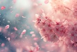 A delicate cluster of cherry blossoms with petals gently falling against a soft, pastel sky symbolizes the arrival of the spring equinox