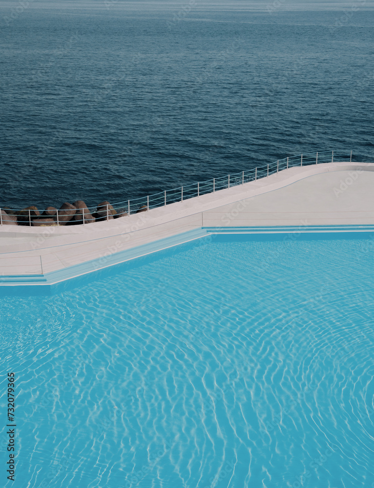 Fototapeta premium Swimming pool by the ocean, minimalist aesthetic summer and vacation background, blue palette, copy space