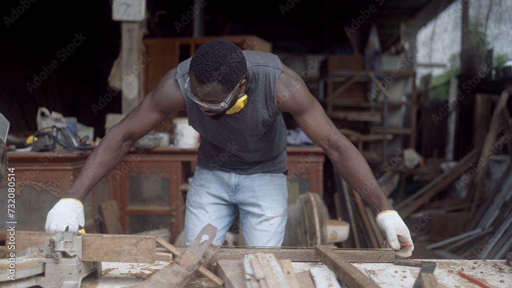 Carpenter repairing furniture in a woodwork