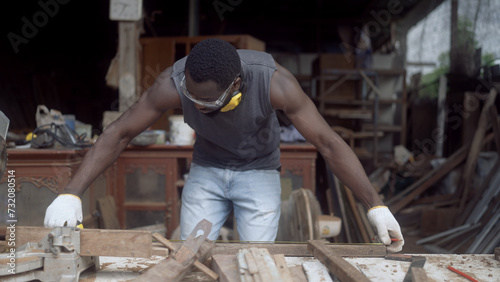 Carpenter repairing furniture in a woodwork