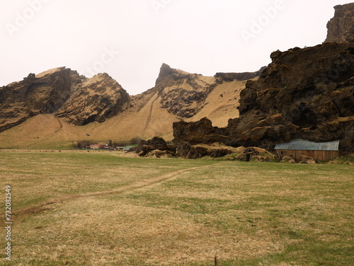 Drangurinn í Drangshlíð is a characteristic tuff rock formation that stands alone on the grazing land of Drangshlíð farm photo