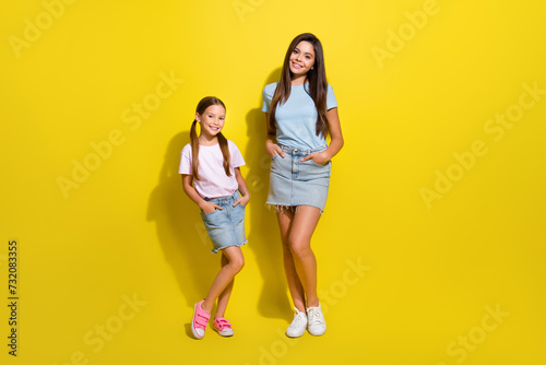 Photo of two charming cute girls best friends enjoy spend free time together isolated over vivid color background