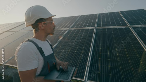 A renewable energy specialist checks the efficiency of solar panels.