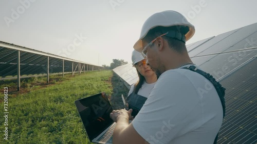 Maintenance personnel of solar panels analyze the operation of the station