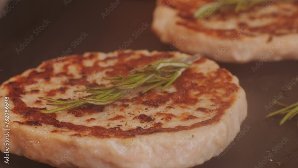 Cooking American fat smash burger on grill close-up. Chiken or fish cutlet smashing by burger press. The chef in kitchen of the restaurant making cutlets for burgers - smash Cooking American fat smash burger on grill close-up. Chiken or fish cutlet smashing by burger press. The chef in kitchen of the restaurant making cutlets for burgers - smash