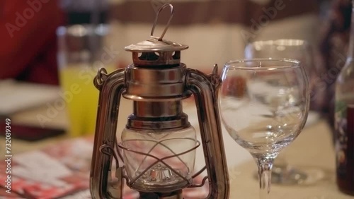 Stylish designer lantern in a fancy restaurant, moody table setting, cinematic 4K video