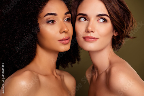 Closeup portrait of two girls clothes off shoulders touching faces look empty space isolated on khaki color background