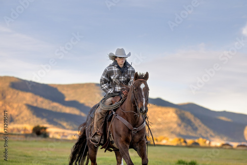 Cowgirl Riding horse across field