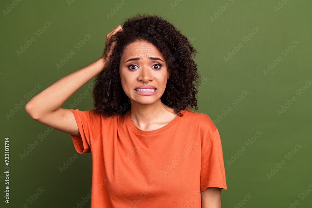 Photo portrait of lovely young lady worried terrified expression dressed stylish orange garment isolated on khaki color background Photo portrait of lovely young lady worried terrified expression dressed stylish orange garment isolated on khaki color background