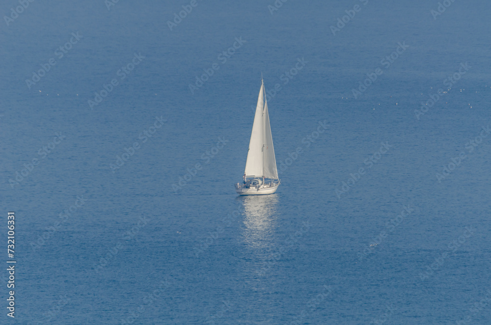 yacht sailing the sea, clear sky and blue water, recreational sport