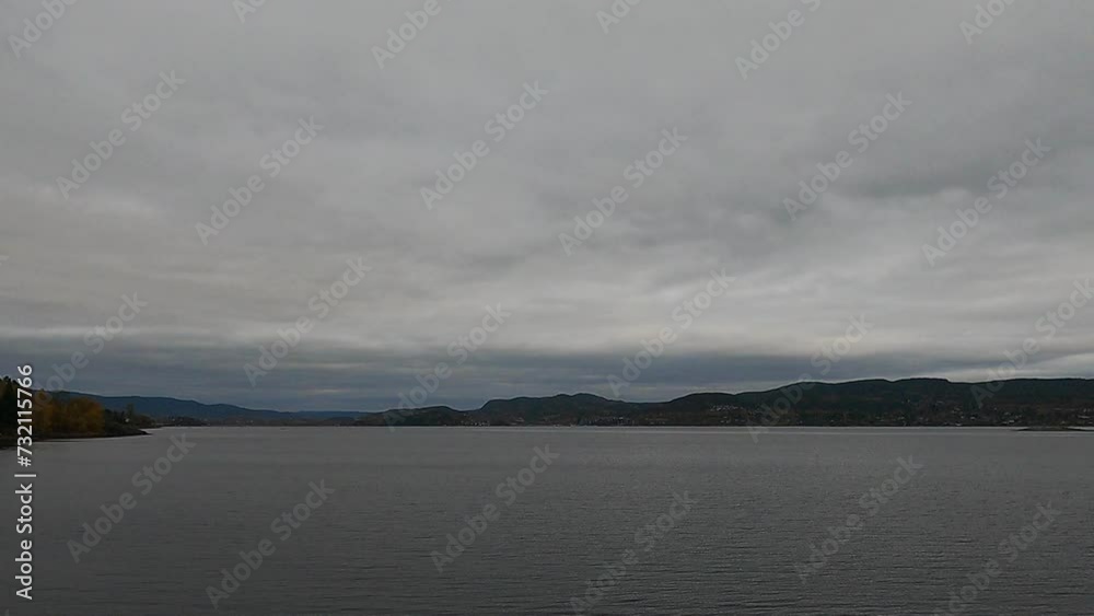 Tranquil Majesty: Norwegian Fjord Unveiled in the Soft Grey Hues of the Day. Tranquil Majesty: Norwegian Fjord Unveiled in the Soft Grey Hues of the Day.