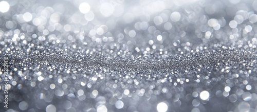 A close up of a grey glitter background with drizzle-like moisture and a precipitation pattern, resembling monochrome photography. The event captures a freezing monochrome atmosphere.
