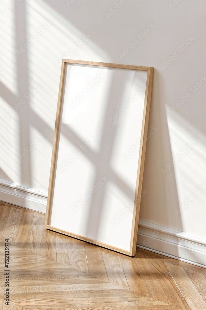 Close up of a Mockup poster frame with wooden frame and blank picture on wood floor. White living room design. View of modern scandinavian style interior. Close up of a Mockup poster frame with wooden frame and blank picture on wood floor. White living room design. View of modern scandinavian style interior.