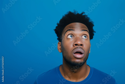 Surprised confused man with space for copy 