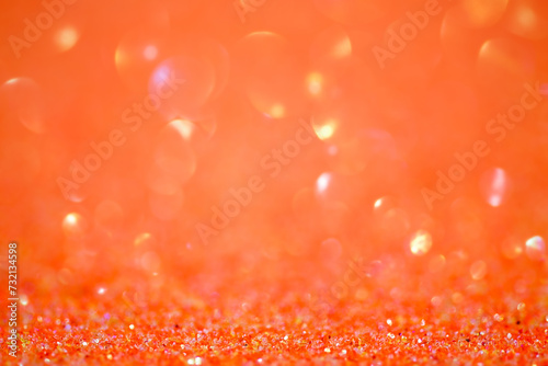 Sparkles defocus light. Glitter paper defocus as background. Orange.