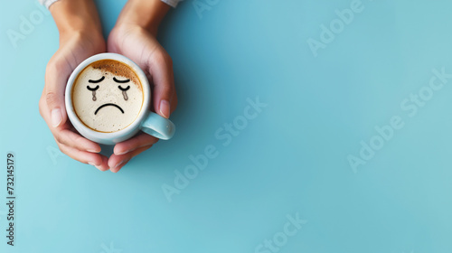 Uma mulher segurando uma caneca de café com um rosto triste  photo