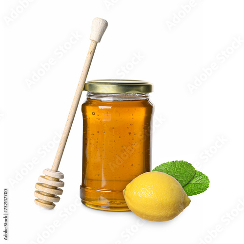 Honey in glass jar, dipper and lemon isolated on white