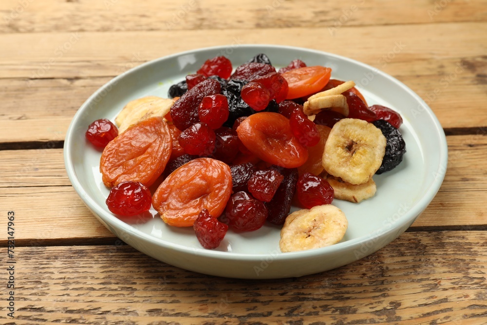 Mix of delicious dried fruits on wooden table, closeup Mix of delicious dried fruits on wooden table, closeup