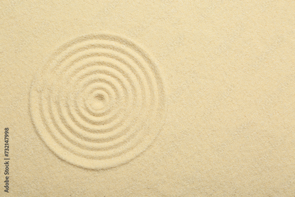 Zen rock garden. Circle pattern on beige sand, top view Zen rock garden. Circle pattern on beige sand, top view