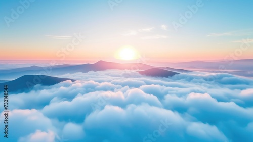 Sunrise over a mountainous landscape covered in clouds