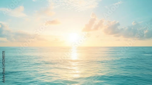 Sunrise over calm sea with clouds in the sky