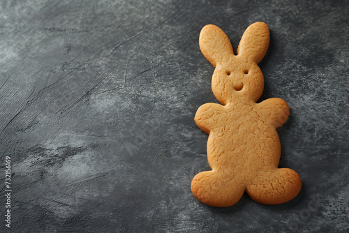 Easter cookie bunny shaped on colored background.