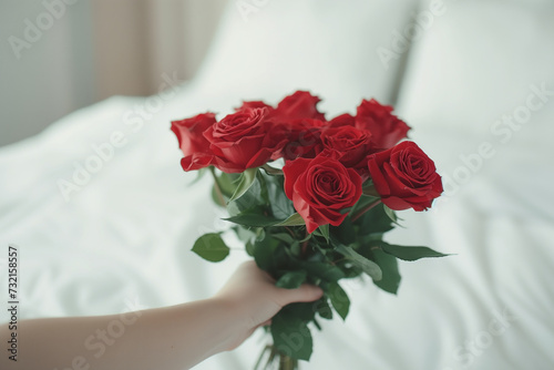 Red rose and personalized hand with Valentine s Day gift Surprise bouquet and flower arrangement on the bed in the house for the anniversary