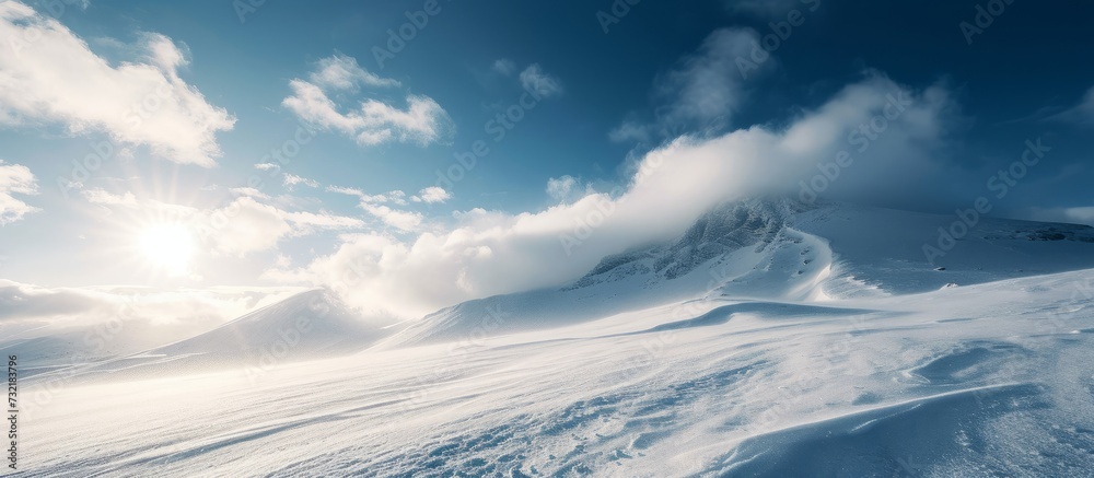 The sun's rays penetrate through cumulus clouds over a snowy mountain, creating a beautiful natural landscape The sun's rays penetrate through cumulus clouds over a snowy mountain, creating a beautiful natural landscape