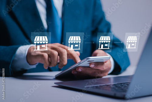 Franchise business concept. Businessman use smartphone and laptop with virtual franchise marketing system icon for global network connection.