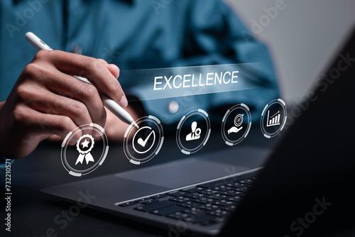 Excellence concept. Businessman use laptop with excellence icon for quality service. Best excellent services rating and satisfaction present