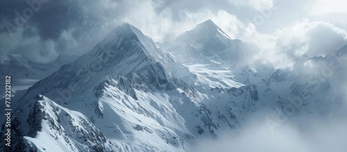 A natural landscape with a mountain covered in snow, an ice cap, and a cloudy sky creating a scenic backdrop.