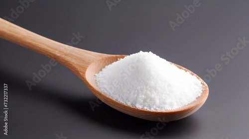 white sugar on wooden spoon