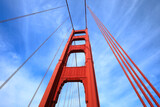The Golden Gate Bridge: Looking up at the famous suspension bridge spanning the bay inlet in San Francisco.