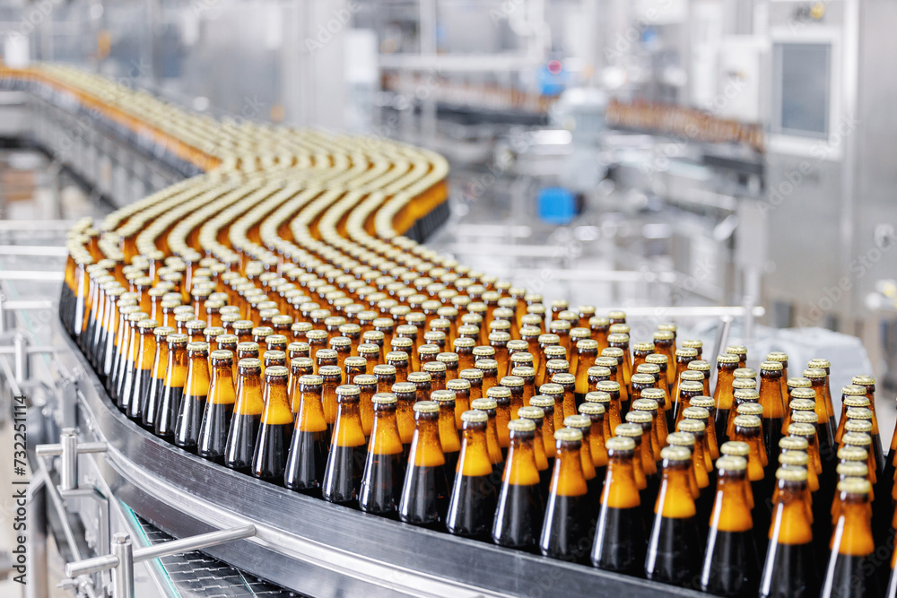 Fototapeta premium Brown glass beer drink alcohol bottles, brewery conveyor, modern production line