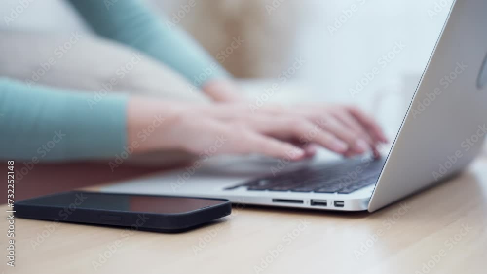 A casual setting with a person typing on a laptop next to a smartphone, highlighting multitasking and connectivity. A casual setting with a person typing on a laptop next to a smartphone, highlighting multitasking and connectivity.