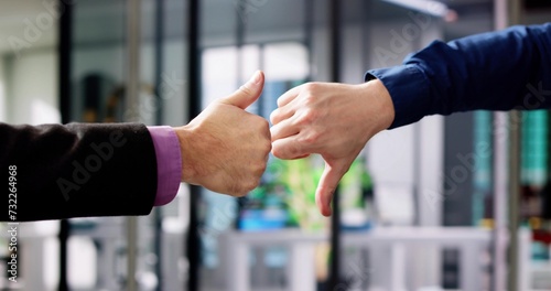 Businesspeople Hands Showing Thumb Up And Thumb Down photo