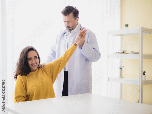 Portrait latin american woman  sick injury with man doctor care caucasian physical therapist two people sitting talk helping support give advice and holding hand arm inside hospital room service