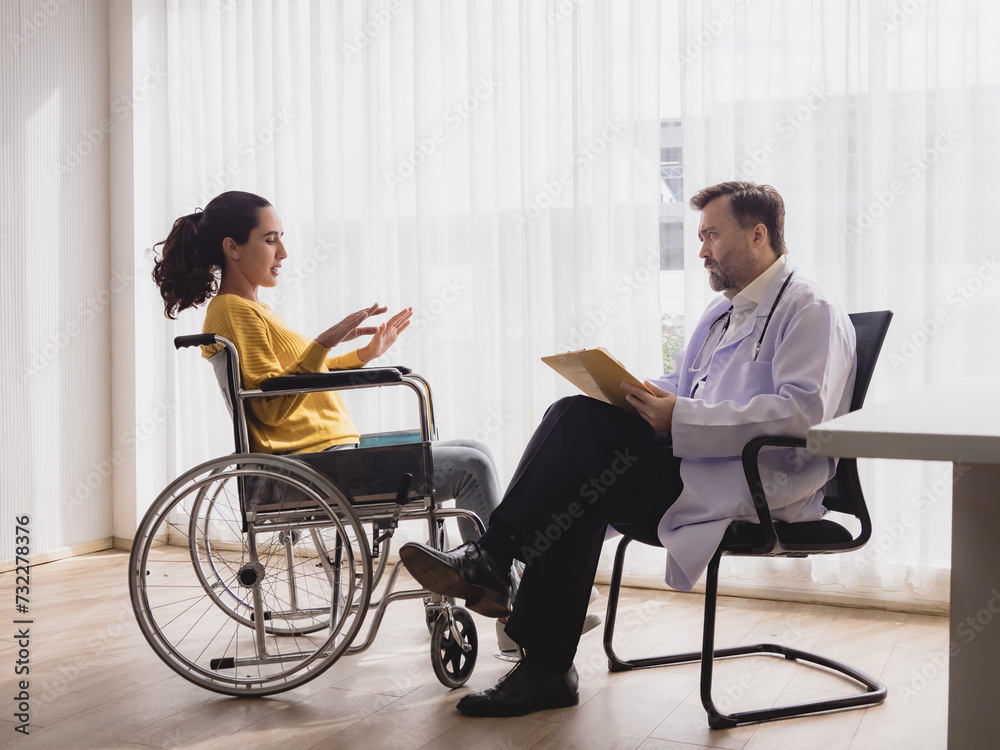 Portrait latin american woman sick sit wheelchair with man doctor caucasian sitting two people check and treat patients talk helping support explain medicine sick person inside hospital room service Portrait latin american woman sick sit wheelchair with man doctor caucasian sitting two people check and treat patients talk helping support explain medicine sick person inside hospital room service