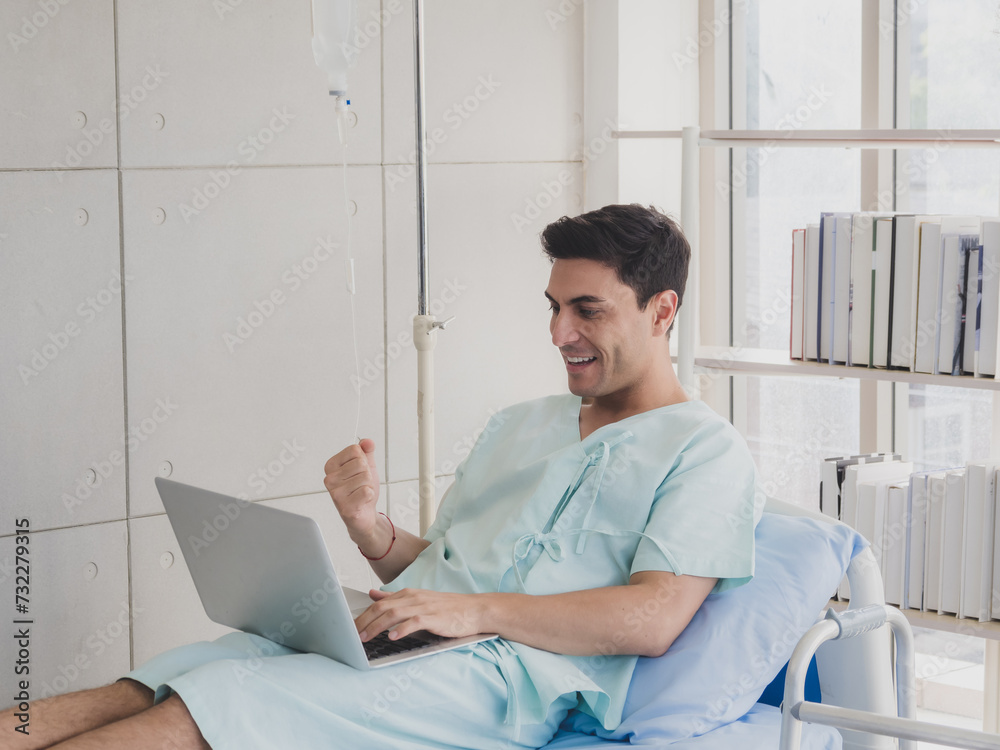 Portrait physical caucasian business man one person sick smile happy laying in bed looking and hand holding computer laptop working job successful while recuperating body in hospital clinic room Portrait physical caucasian business man one person sick smile happy laying in bed looking and hand holding computer laptop working job successful while recuperating body in hospital clinic room