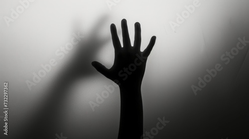 Hand silhouette on grey background. Blurred human hand shape out of focus