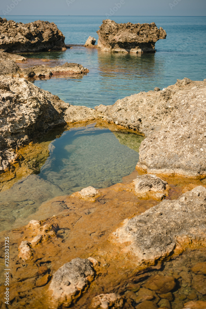 Tide pools of sea water along the rocky shore of the island of Crete