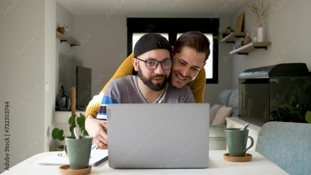 Homosexual couple waving on a video call with family or friends. Homosexual couple waving on a video call with family or friends.